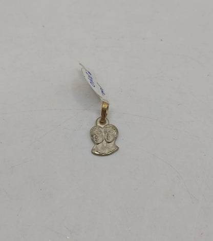 Dije dos caras ORO 10k peso .9gr, usado